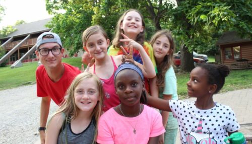 Campers and counselor at campfire