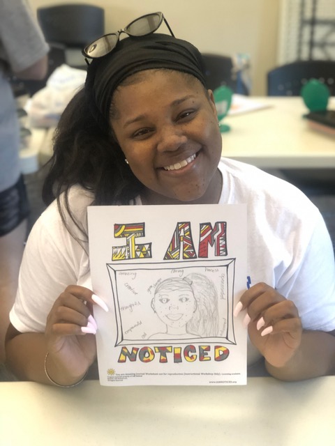 Wildwood camp counselor displaying her Noticed artwork.