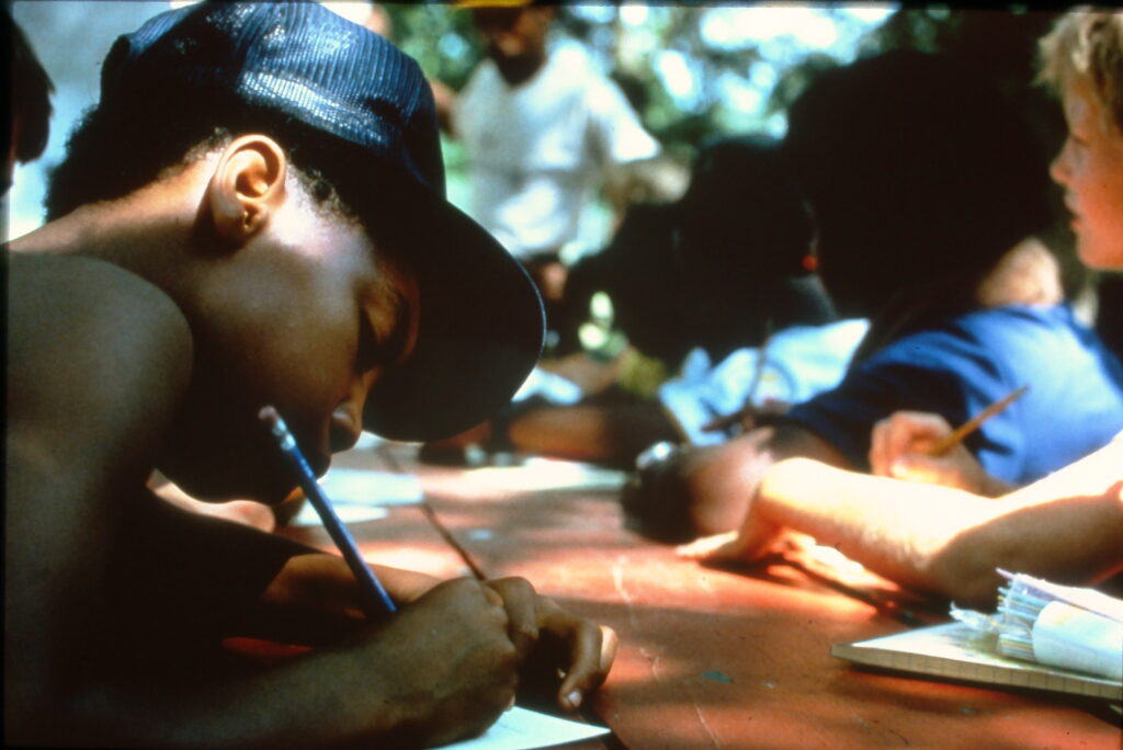 Wildwood campers writing in the outdoors